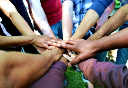 diverse group buy-in all hands huddle